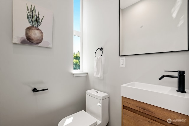 bathroom featuring vanity and toilet