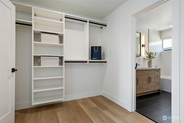 walk in closet with hardwood / wood-style floors