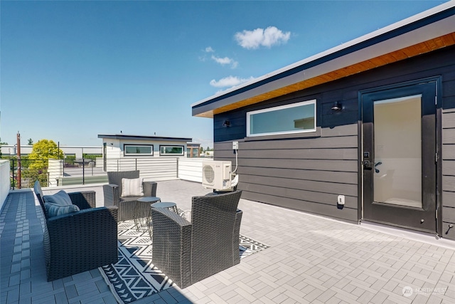 view of patio / terrace with a balcony, an outdoor hangout area, and ac unit