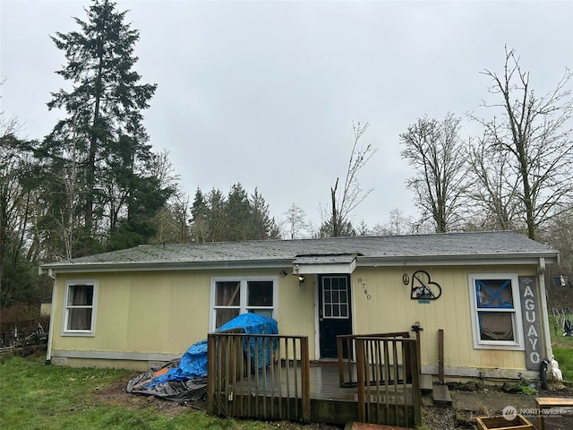 back of property with a wooden deck