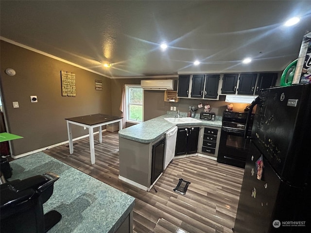 kitchen featuring sink, hardwood / wood-style floors, a wall mounted AC, ornamental molding, and black appliances