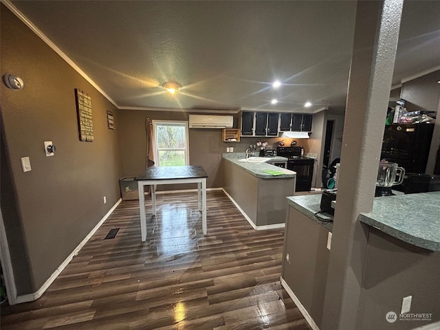 kitchen with an AC wall unit, black electric range, dark hardwood / wood-style floors, and kitchen peninsula