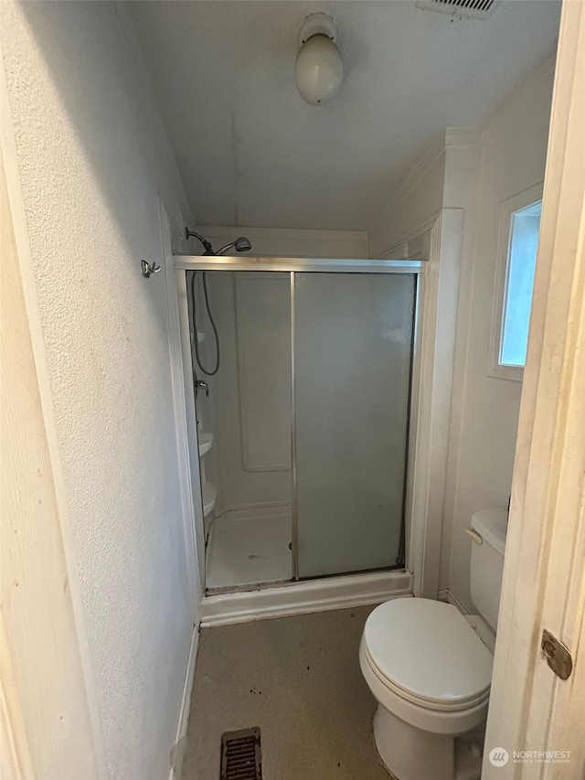 bathroom with toilet and walk in shower