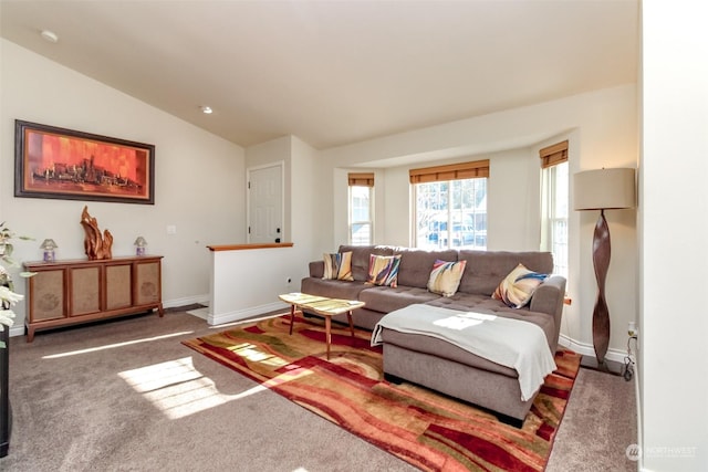 living room with vaulted ceiling and dark colored carpet