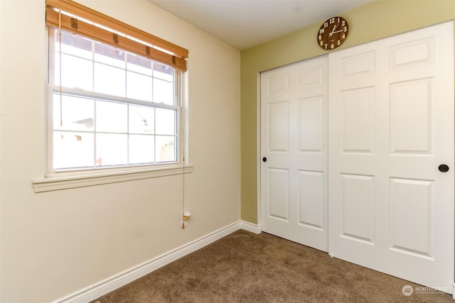 unfurnished bedroom featuring carpet floors and a closet