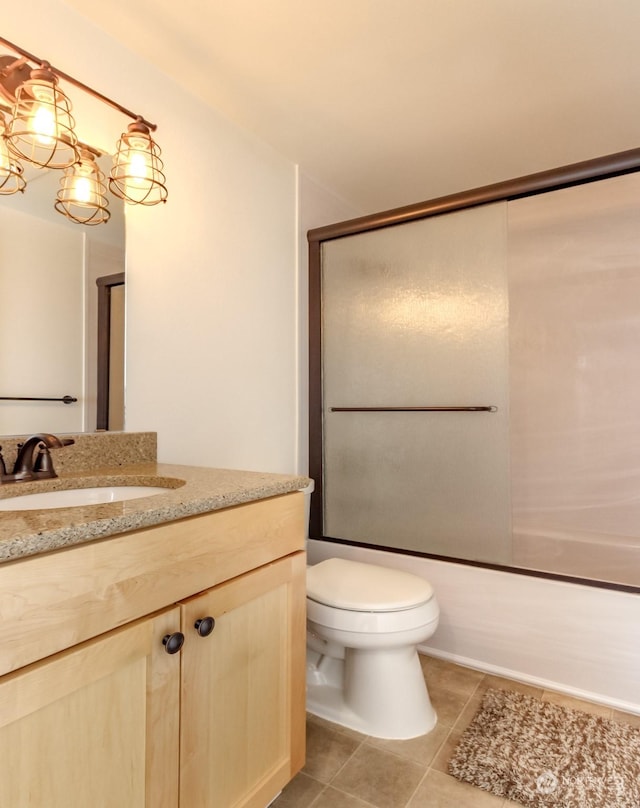 full bathroom with toilet, vanity, combined bath / shower with glass door, and tile patterned flooring