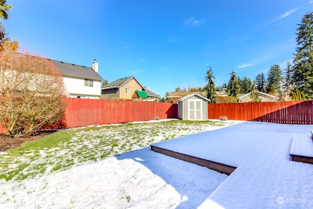 snowy yard with a shed