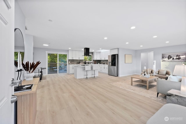 living room with sink and light hardwood / wood-style floors