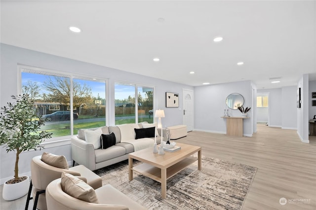 living room with a wealth of natural light and light wood-type flooring