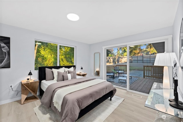 bedroom featuring light wood-type flooring and access to outside