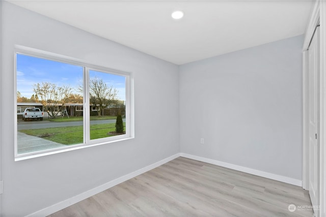 spare room with light hardwood / wood-style floors