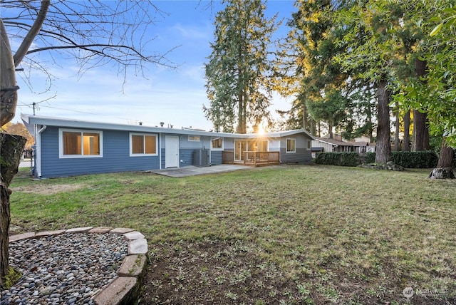 rear view of house featuring a yard and cooling unit