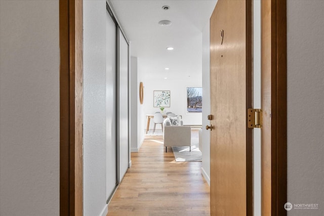 hallway with light hardwood / wood-style flooring