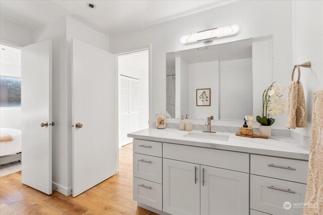 bathroom with vanity and hardwood / wood-style floors