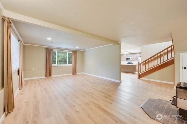 unfurnished living room with ornamental molding and light hardwood / wood-style flooring