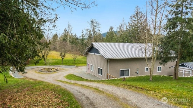 view of side of property with a lawn