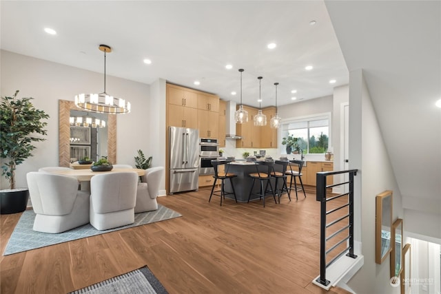 dining room featuring an inviting chandelier and light hardwood / wood-style flooring