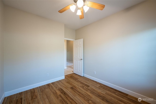 empty room with light hardwood / wood-style floors and ceiling fan