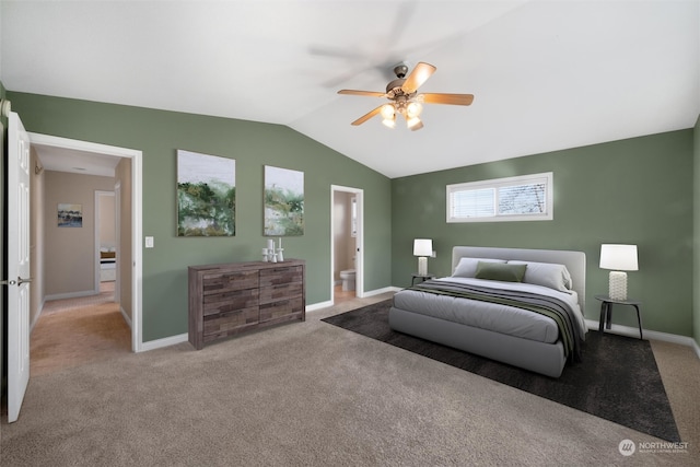 bedroom with lofted ceiling, ensuite bath, light carpet, and ceiling fan