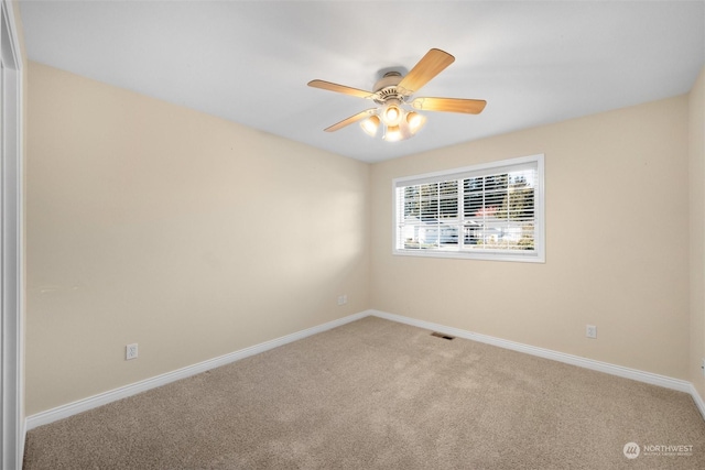 empty room with ceiling fan and carpet