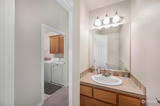 bathroom with vanity, toilet, and washer and clothes dryer