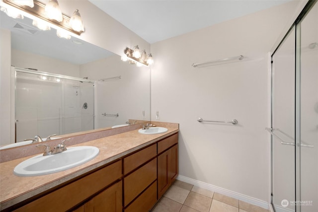 bathroom featuring vanity, a shower with door, and tile patterned flooring