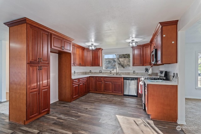 kitchen with stainless steel appliances, sink, a textured ceiling, and dark hardwood / wood-style flooring