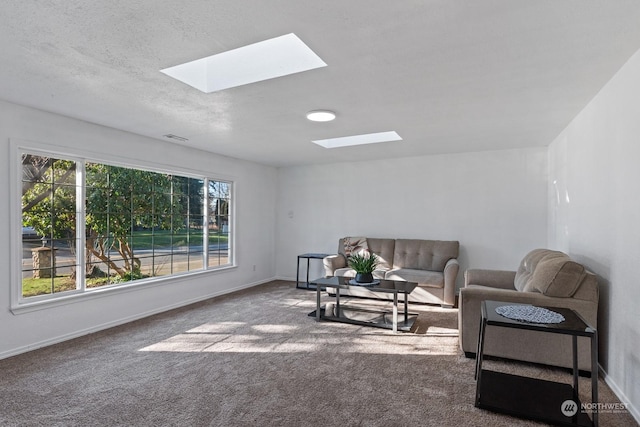 carpeted living room with a textured ceiling and a skylight