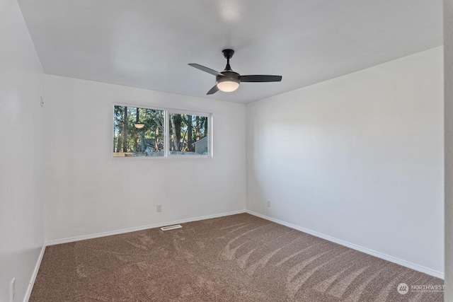 carpeted spare room featuring ceiling fan