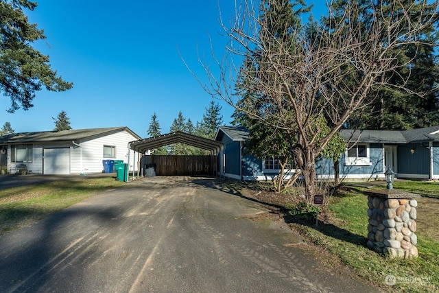 ranch-style house featuring a carport and a front yard