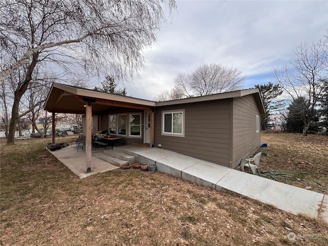 exterior space featuring a patio and a lawn