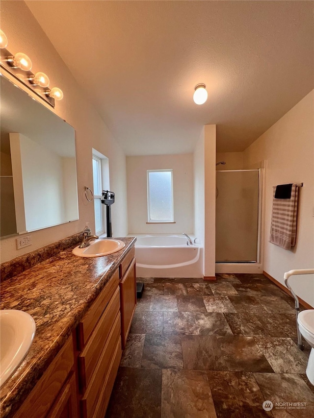 full bathroom with vanity, toilet, and separate shower and tub