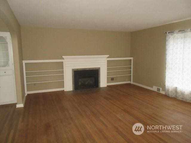 unfurnished living room featuring dark hardwood / wood-style floors