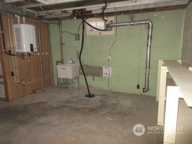 basement featuring water heater and sink