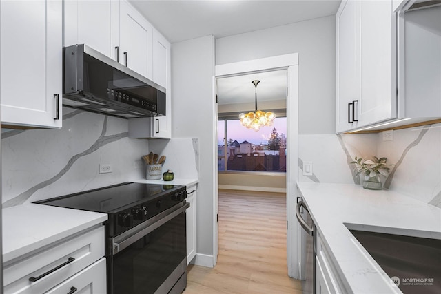 kitchen with white cabinetry, stainless steel appliances, an inviting chandelier, and decorative backsplash