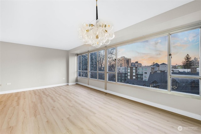 unfurnished sunroom with a notable chandelier