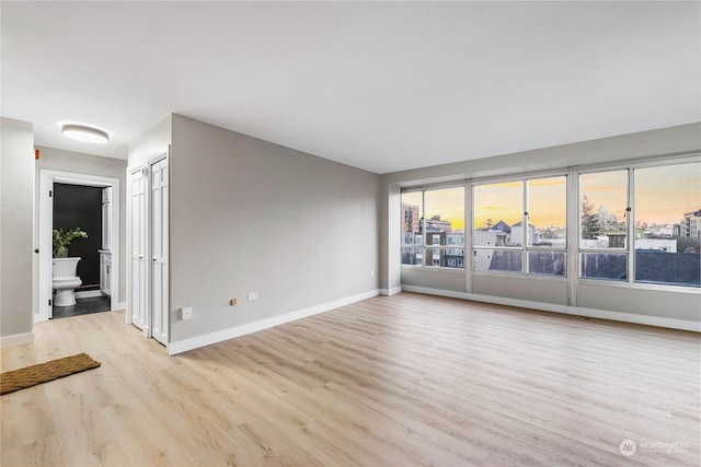 spare room with light hardwood / wood-style flooring