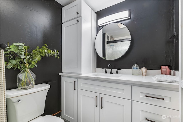 bathroom with vanity and toilet