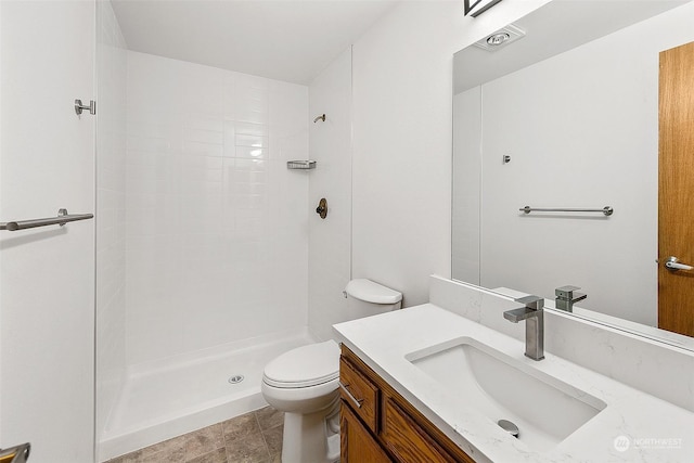 bathroom featuring vanity, toilet, and walk in shower