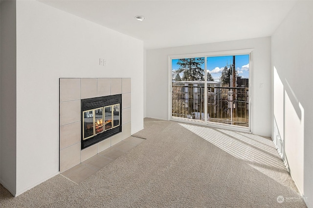 unfurnished living room with light carpet and a fireplace