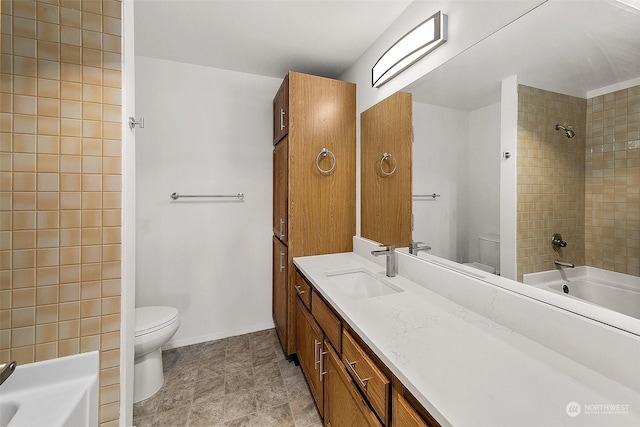 full bathroom featuring vanity, toilet, and tiled shower / bath combo