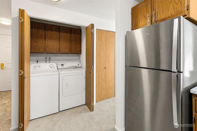 laundry area featuring washer and dryer and light colored carpet