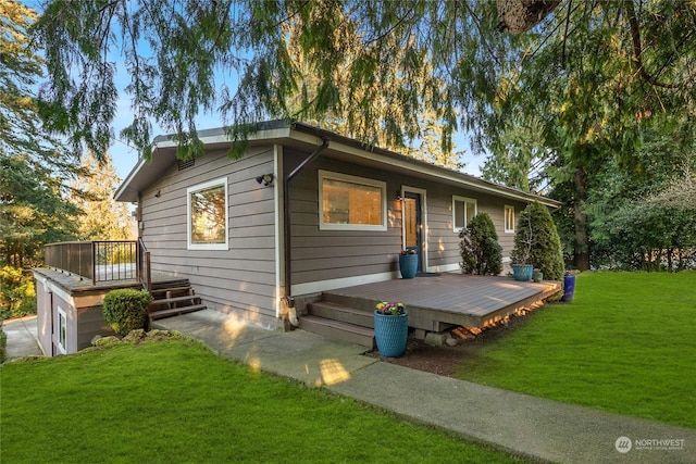 view of front of house featuring a front yard and a deck