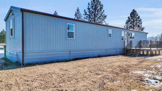 rear view of property with a wooden deck