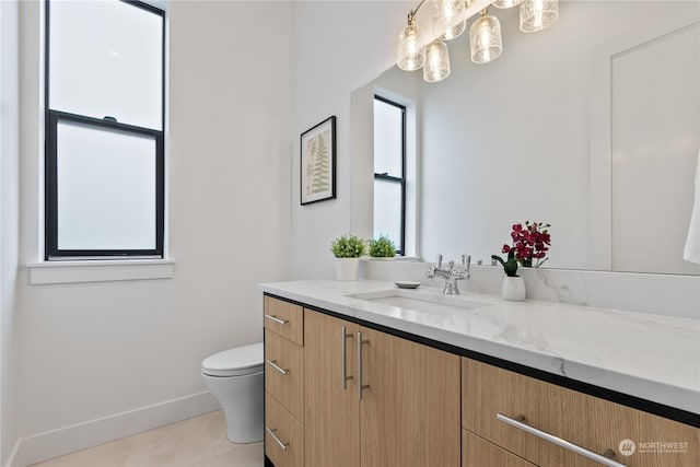 bathroom featuring vanity, tile patterned floors, and toilet