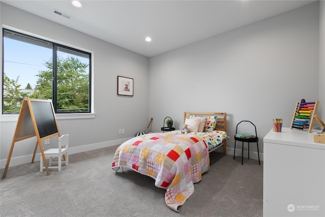 bedroom featuring washer / dryer and carpet flooring