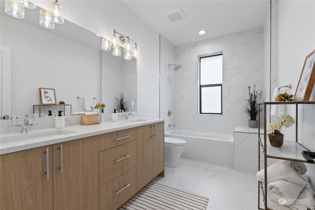 full bathroom with tiled shower / bath, vanity, and toilet