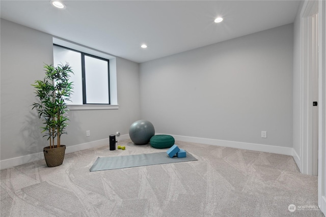 exercise room featuring light colored carpet