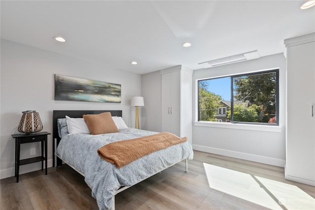 bedroom with hardwood / wood-style floors