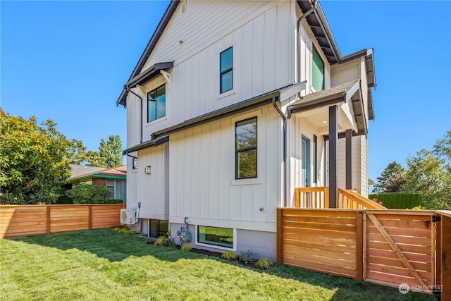 rear view of house featuring a yard